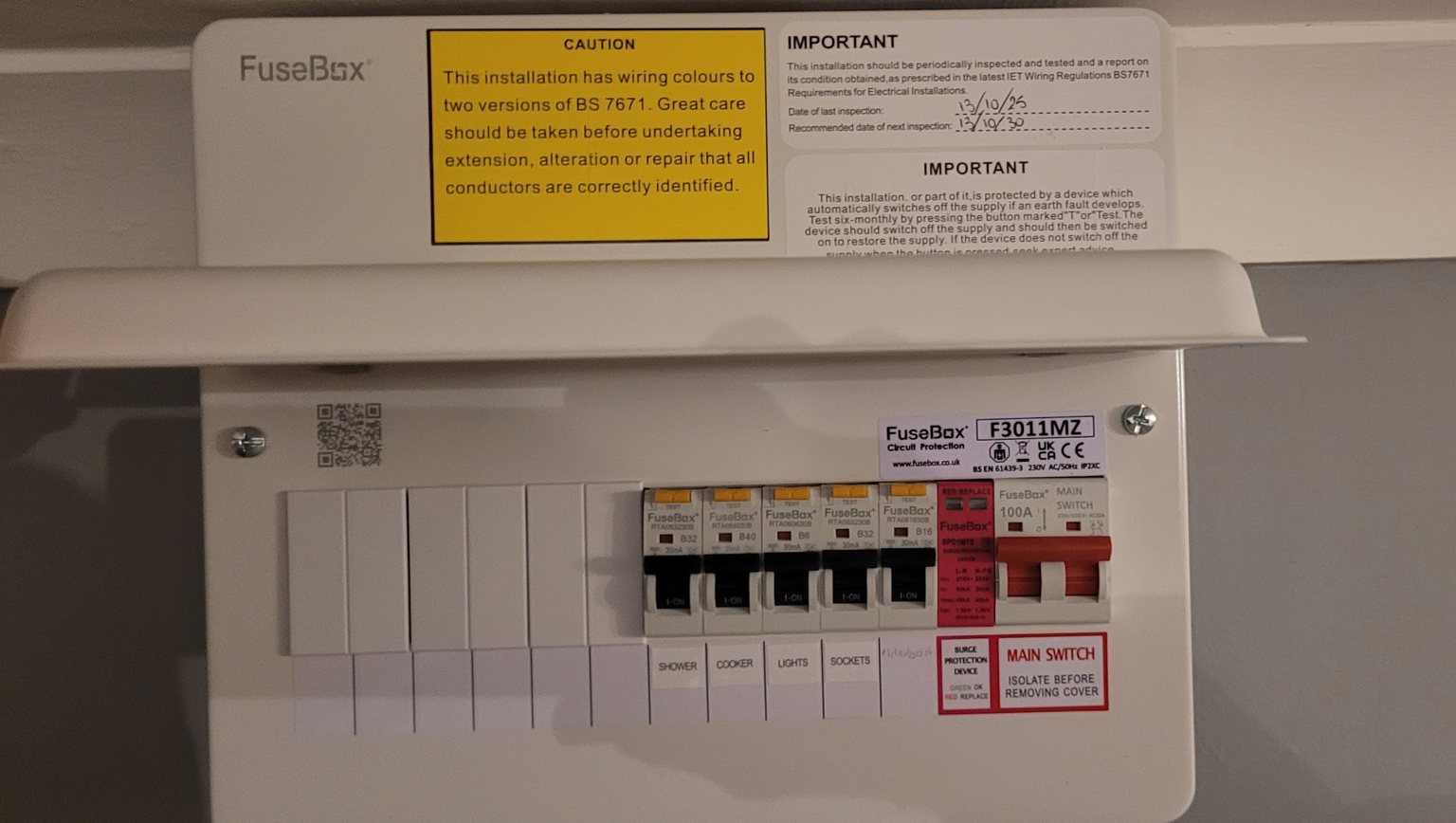 A new consumer unit with labelled circuits for the shower, cooker, lights and sockets, a surge protection device and a 100A main switch